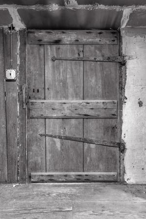 Board and battem door in attic hung on reused hinges, 1792